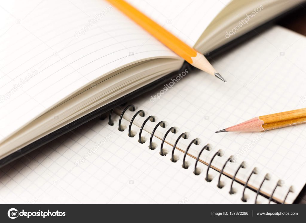 Pencils On The Pages Of An Open Notebook For Records